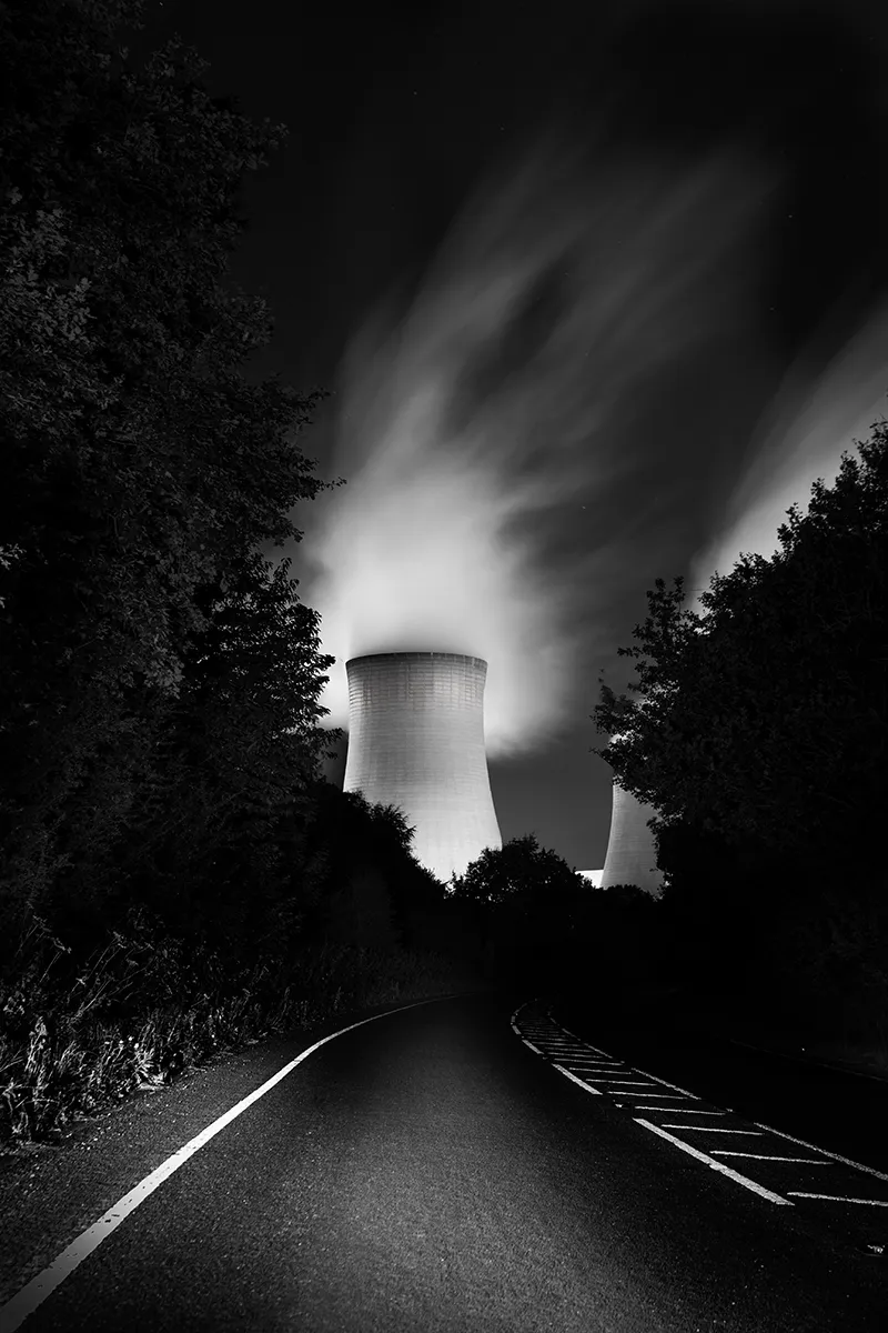 Portrait long exposure of the road to Drax Power Station with steam above