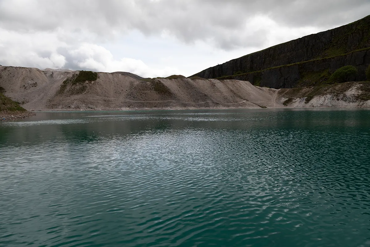 Hoffman Quarry and its cliffs under a grey sky
