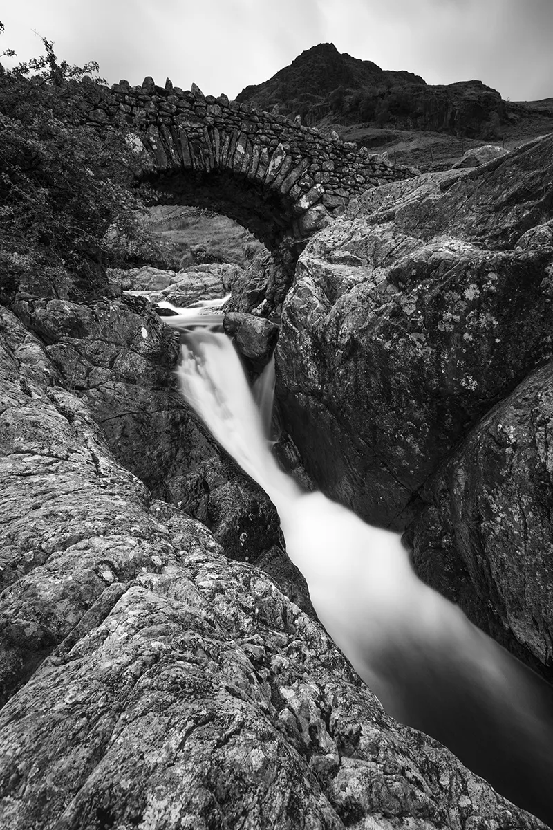 Black and white long exposure of Stockley Bridge with the river blurred beneath it