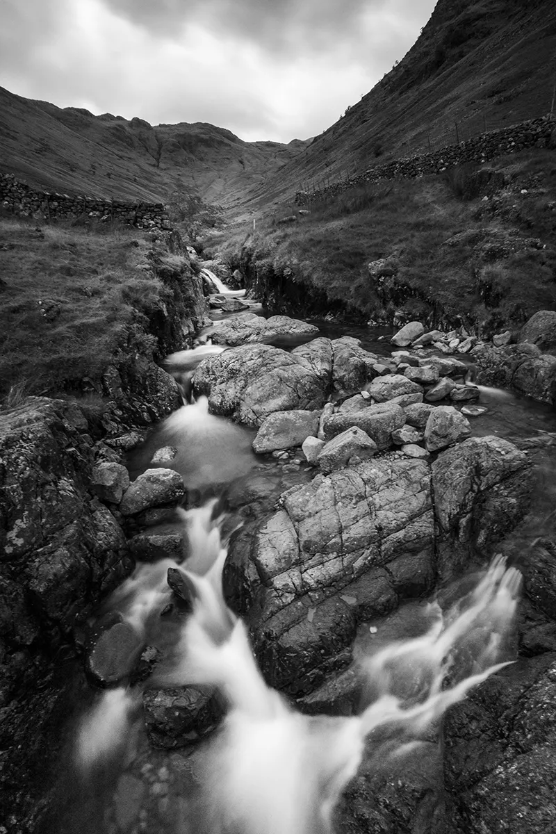 Black and white long exposure of the waterfall in the gorge above Stockley Bridge