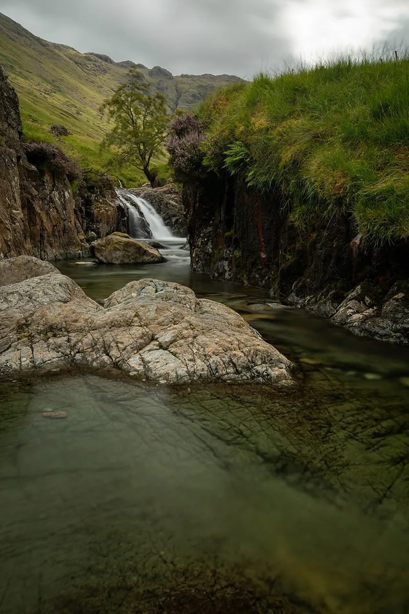 Pool below a waterfall above Stockley Bridge with a polariser, showing clear green water and stones beneath