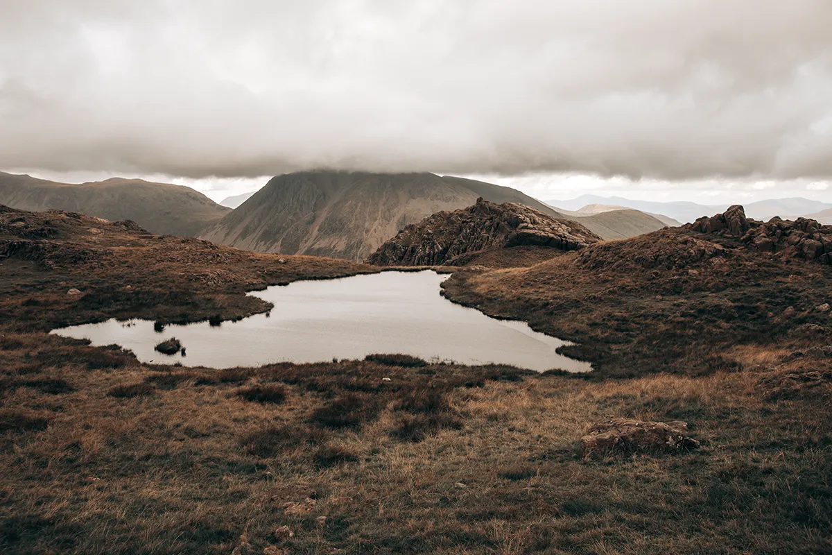 Looking back down to a tarn far below on the way up Scafell Pike