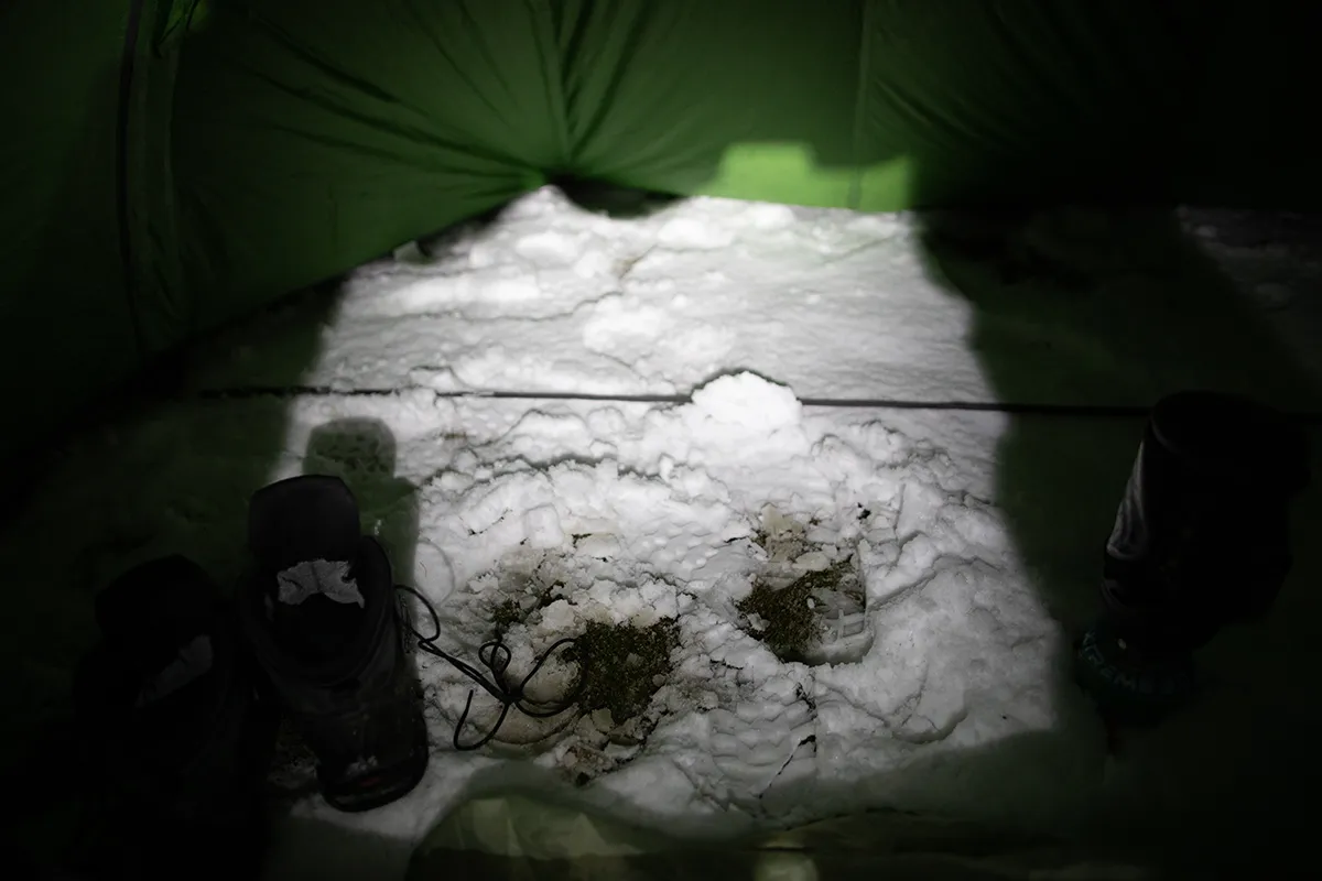 Inside the Vango Pulsar Pro 300 on Helvellyn, with snow outside the door